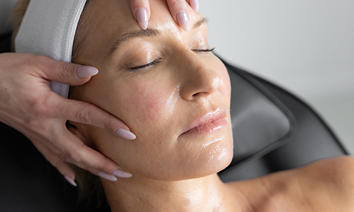Woman receiving facial treatment